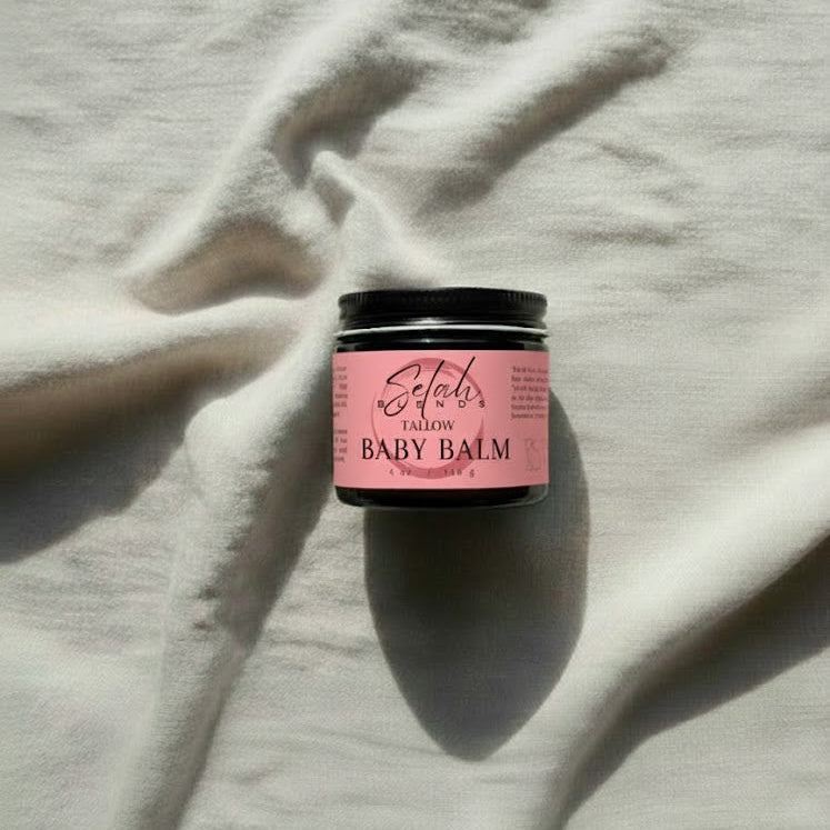 Pink baby balm jar on a light fabric background