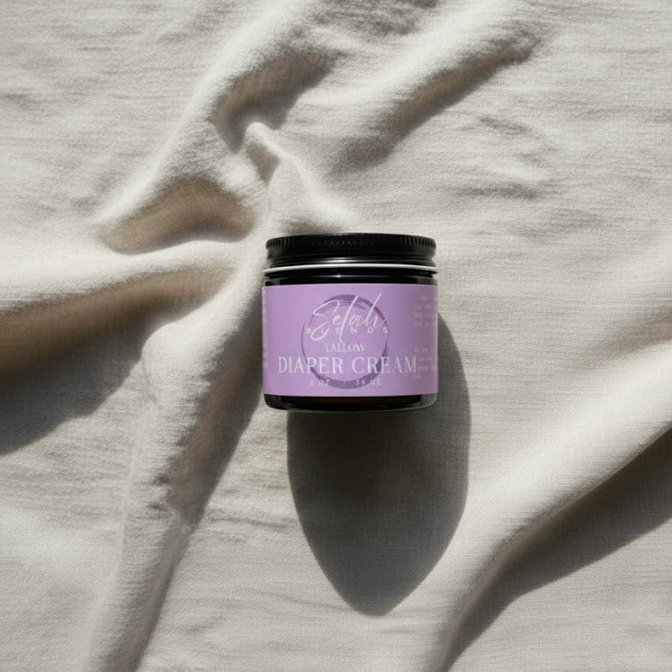 Purple jar of diaper cream on a textured beige surface